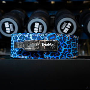 Blue leopard Trackfie lever belt in front of dumbbells