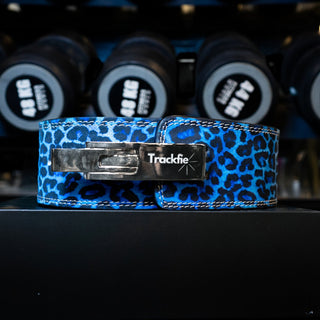 Blue leopard Trackfie lever belt in front of dumbbells