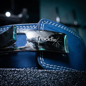 Close-up of the buckle on a navy blue Trackfie lifting belt