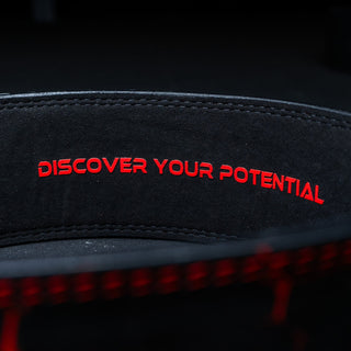 Inside of a red Unlisted Strength lever belt with the text 'discover your potential'