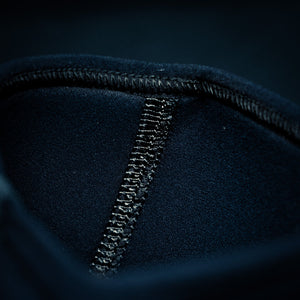 Very close-up of the stitching on black Trackfie knee sleeves