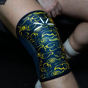 Close-up of yellow Trackfie knee sleeves on a man's knee