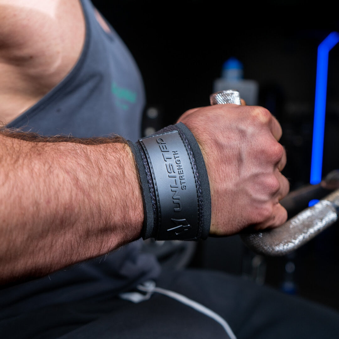 Close-up of black lifting straps being used for rows exercise